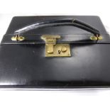 A Vintage Black Leather Jewellery Box, the box having black velvet lining with pull out ring tray