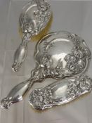 A Solid Silver Art Nouveau Lady's Dressing Table Set, comprising clothes brush, hair brush and