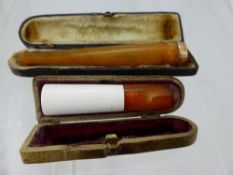 An Amber and 9 ct Gold Cigarette Holder, Birmingham hallmark dd 1912 mm A..F.& Co., in the