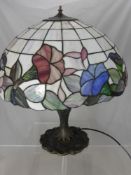 A Tiffany Style Lamp on Naturalistic Base, the shade depicting a Morning Glory design, approx 70 cms