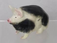 A Small Wemyss Black and White Pottery Pig Money Box, the pig having some black markings and