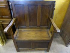 An Oak Monk's Table/Settle, having panelled back with lift up seat, approx 81 x 46 x 107 cms