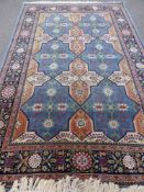A Woollen Persian Style Rug, the rug having a light blue background with six central medallions,