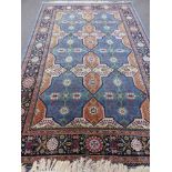 A Woollen Persian Style Rug, the rug having a light blue background with six central medallions,