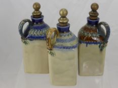 Three 19th Century Royal Doulton Lambeth Ware Decanters, with decorative glaze to the top and