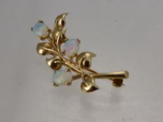 A 9 Ct Gold and Opal Brooch, in the form of a flower, mm C & F, approx wt 6 gms.