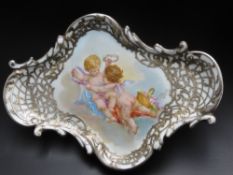 A Porcelain Cherub Putti Dish, with silver overlay, signed Francois Boucher, with Sevres mark to