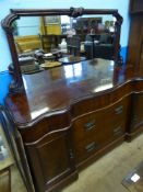 A Mahogany Serpentine Fronted Mirror Backed Sideboard, the sideboard having top three drawers to