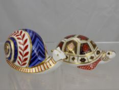 Two Royal Crown Derby Bone China Figurines, depicting a tortoise and a snail. (2)