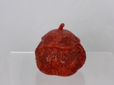 A Chinese Red Lacquer Style Pot and Cover, of melon form with intricate vine carving, approx 15 cms