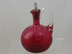 A Victorian Cranberry Glass Decanter, with pewter stopper, etched with foliate design.