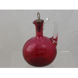 A Victorian Cranberry Glass Decanter, with pewter stopper, etched with foliate design.