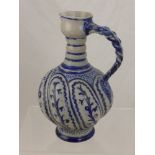 An Antique German Stone Ware Pottery Ale Jug with decorative blue floral design with pie crust