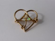 A Lady's 9 Ct Gold and Opal Heart Shaped Brooch, four 4 x 3 total wt 4.4 gms.