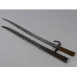An Antique French Brass Hilted Yatagan Bayonet, the bayonet having steel scabbard numbered R64965