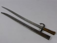 An Antique French Brass Hilted Yatagan Bayonet, the bayonet having steel scabbard numbered R64965