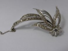 A Lady's Platinum and Diamond Floral Brooch, 1 x 25 pt brilliant cut, 40 pts bag cuts, 66 pts of 8