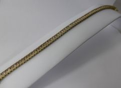 A Lady's 14 Ct Yellow Gold Diamond Tennis Bracelet, approx 6.17 cts of princess cut dias, 18 cms