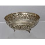 A Silver Bowl, with intricate vine carving with three feet, stamped 830 mm KM, approx