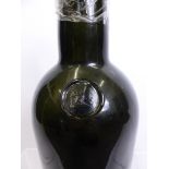 A large 19th Century Green Glass Sealed Wine Bottle, the bottle with remnants of contents the seal