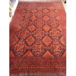 A Woollen Middle Eastern Carpet, the carpet having red, midnight blue and white background with