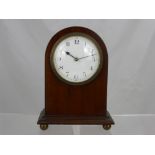 An Edwardian French Mahogany Mantel Clock, the clock having white enamel face on ball feet.