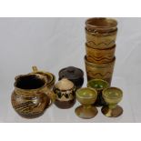Sidney Tustin Winchcombe Pottery Including Four Beakers, a pepper, tea strainer, lidded pot, milk