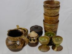 Sidney Tustin Winchcombe Pottery Including Four Beakers, a pepper, tea strainer, lidded pot, milk