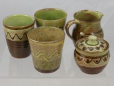 Sidney Tustin, Winchombe Pottery Three Green Glaze Beakers sugar bowl and cover, soup dish and a