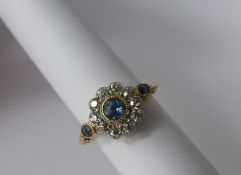 A Lady's 18 Ct Platinum Diamond and Aquamarine Cluster Ring, 1 x 3.5 mm Aqua, 2 x 2 mm Aqua,