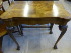 A Victorian Style Walnut Swivel Top Card Table, the table having scalloped corners on ball and