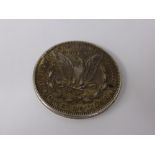 An 1884 Solid Silver Liberty Morgan Dollar, spread eagle back with Liberty head above date.