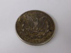 An 1884 Solid Silver Liberty Morgan Dollar, spread eagle back with Liberty head above date.