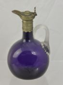 A 19th Century Amethyst Glass Decanter, with pewter collar and ribboned handle.