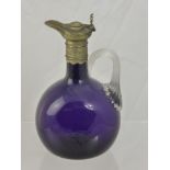 A 19th Century Amethyst Glass Decanter, with pewter collar and ribboned handle.