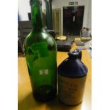 large green bottle and stone bottle