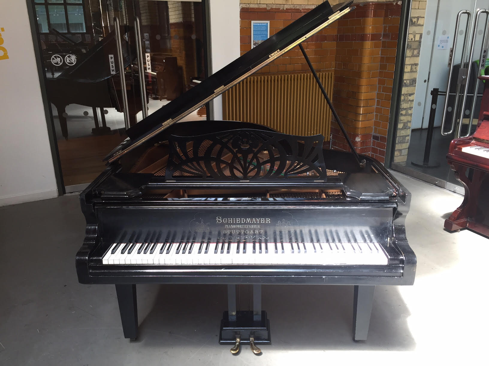 Kemble C.1990 A Model Cambridge 10 upright piano in a mahogany polyester case togeather with a