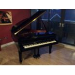 Kawai C.2011 A 5ft 10 Model RX2 grand piano in a black polyester case raised on square tapered