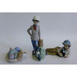 Two Nao porcelain boy and dog  figures and a Nao model of a sleeping dog in a basket (3)