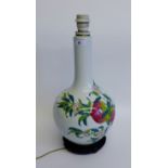 White glazed table lamp base with fruit and flower decoration, on a hardwood stand, 40cm high