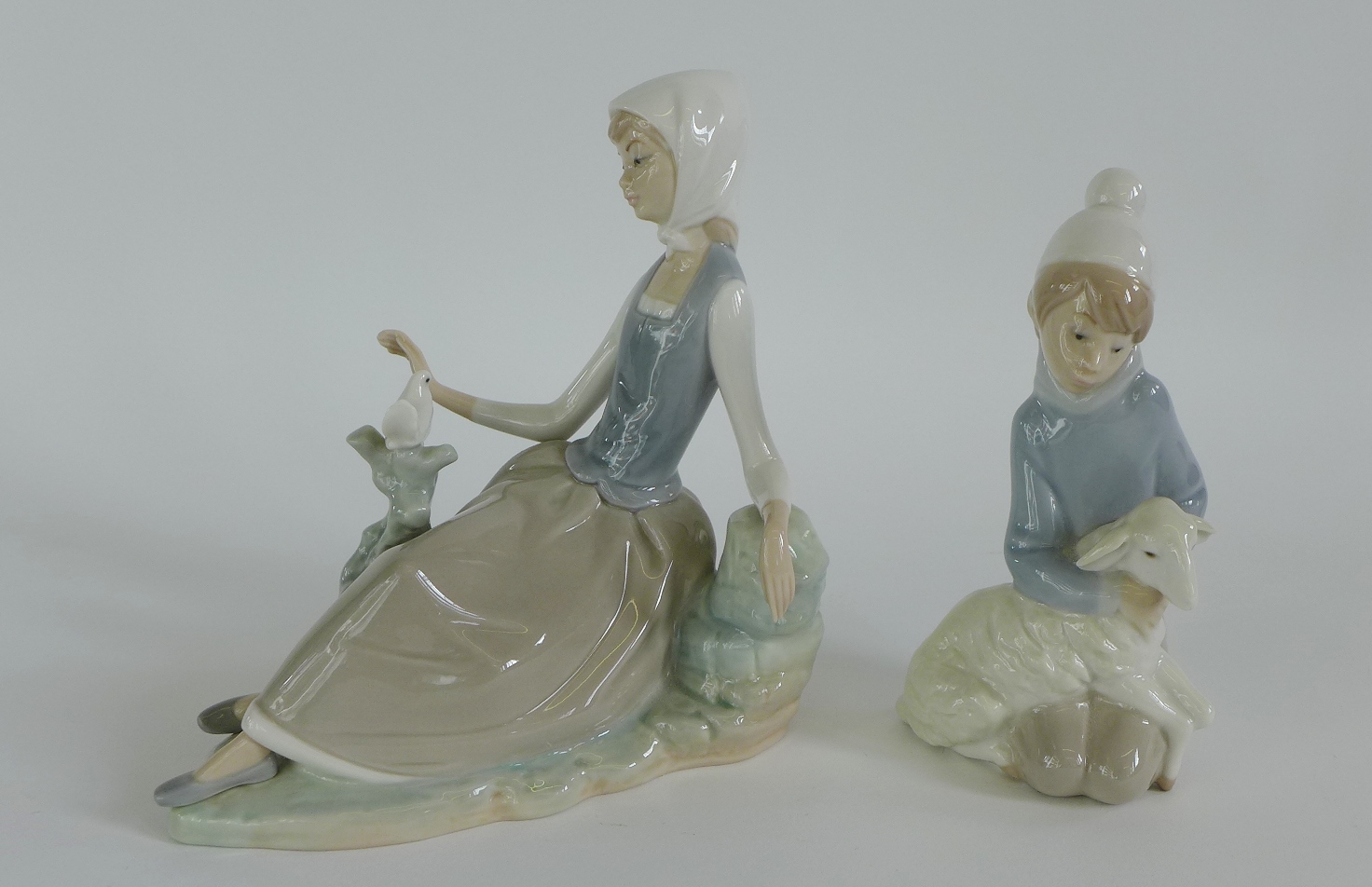 Lladro Daisa figures to include a girl with a dove and a boy with a lamb (2) 1cm high
