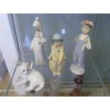 Royal Copenhagen figure of a cat together with three Lladro porcelain figures to include a clown,