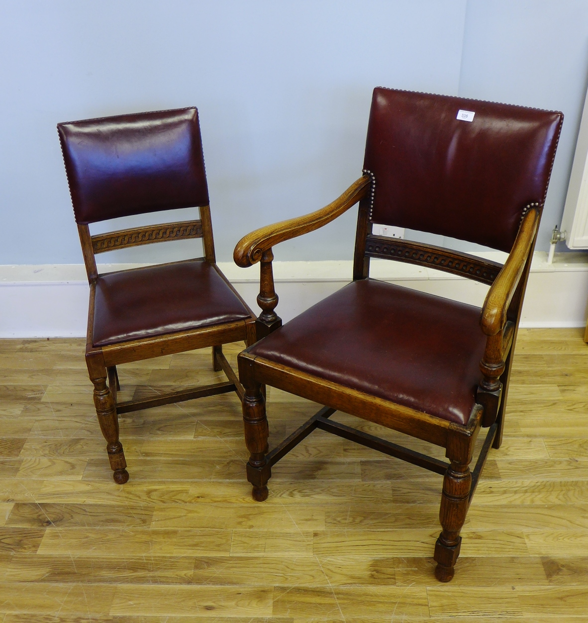 A set of six 19th century stained oak dining chairs having padded leather back supports and slip