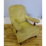 A late Victorian lounge chair having a mahogany frame with padded back support, arm rest and seat,