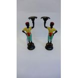 A pair of contemporary cold painted bronze 'Blackamoor' figure candlesticks, on socle bases, 27cm