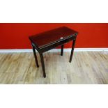 A George III mahogany fold over tea table having a moulded rectangular edge raised on section