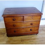 A late Victorian mahogany chest of drawers having two short over three long drawers raised on