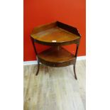 A 19th century mahogany corner wash stand having a gallery back over three short drawers raised on