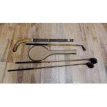 A collection of vintage sporting equipment to include three hickory shafted golf clubs and hockey