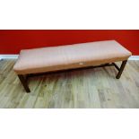 A contemporary upholstered mahogany framed window seat, 140 x 46cm